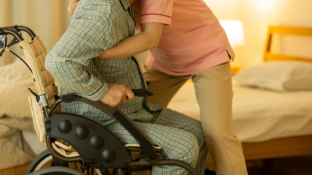 Carer helping someone into bed