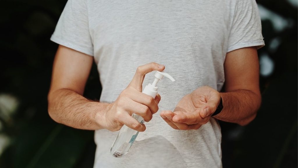 Man sprays hand sanitiser