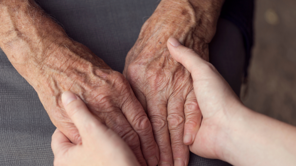 Image of carer holding hands