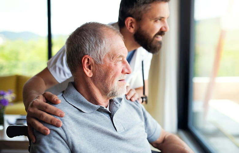 Elderly man accompanied by a nurse